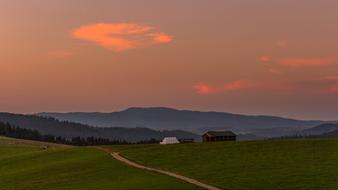 Sunset red sky green grass Landscape