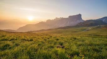 green valley on the background of the mountains at sunrise