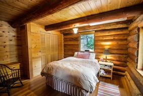 photo of a bedroom in a log house