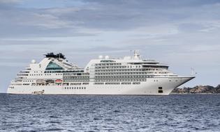 Beautiful waterscape with the white cruise ship, on the blue water with ripple