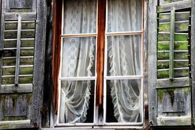 vintage curtains on window of old wooden House