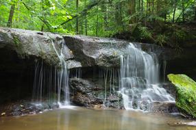 small waterfall in the forest in the valley