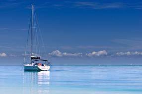 distant view of the yacht on the blue ocean water