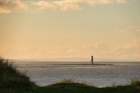 Lighthouse, among the water, on the beautiful view from the Sligo, Lighthouse, at colorful sunset