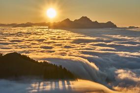 sunset over foggy alpines