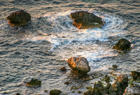 Beautiful landscape of the sea with rocks, in colorful sunset