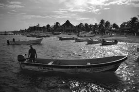 boats on the coast of puerto morelos in black and white background