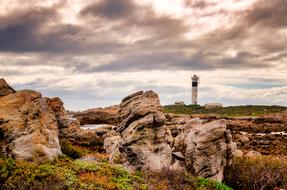 landscape of Rocks and Lighthouse Sky