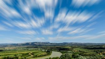 Beautiful and colorful landscape with the Ebro River, among the fields and mountains in Miravet, Spain