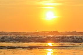 Beautiful landscape of the beach of the sea in Denmark, with the waves, at beautiful and colorful sunset