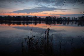 sky mirroring on calm water at dusk