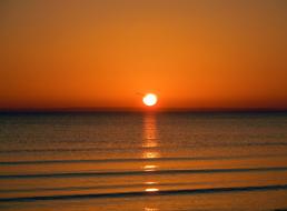 Beautiful landscape with the colorful sunrise on horizon, above the sea