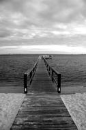 monochrome photo of a wooden sea pier in Florida