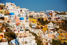 Beautiful Santorini, with the colorful houses, at blue sky on background, in Greece