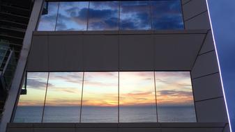 view from the window of a modern building at sunset over the sea