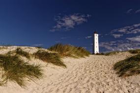 lighthouse on sand beach on north sea