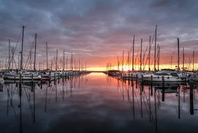 Beautiful waterscape with boats in the port of High- Dune at colorful sunrise