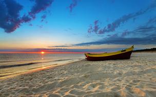 boat on sand Beach at Sunset