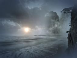 mystical photo of the evening sea and foggy rocks on the coast