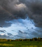 dramatic sky over green field