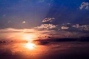 colorful sunset in the clouds of a blue sky
