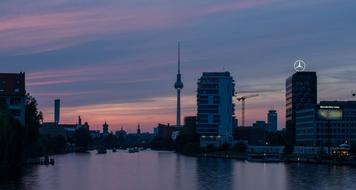 Cityscape of Berlin, with the water, in Germany, at beautiful and colorful twilight