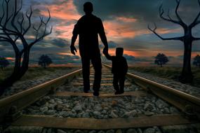 Silhouette of the Mitch Acker with the child, on the railway, at colorful sunset