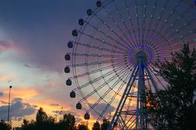 Ferris wheel in the amusement park in the evening