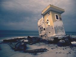 Decay Building on the beach in cloud dusk