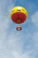 yellow red balloon flying high in the sky