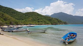 boats on the beach in Tayrona Park