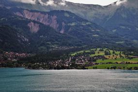 village near the lake at the foot of the alpine mountains
