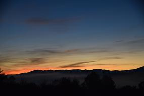 idyllic sunset behind the mountains on the horizon