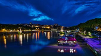 Beautiful landscape with the river, among the buildings and colorful lights in France