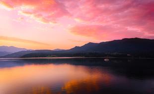 Beautiful and colorful landscape of the lake, with the reflections, among the mountains, under the beautiful and colorful sunset, among the clouds, in Romania