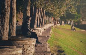 man under the trees in the park