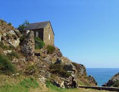 Beautiful house on the colorful, rocky shore in Brittany, France