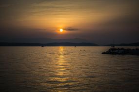 sun near the clouds over the sea during sunset