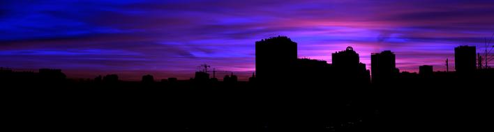 Beautiful panorama, with the silhouettes of the buildings, in Russia, at beautiful and colorful sunset, among the clouds
