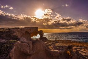 Rock sky clouds sun