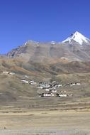 Village on snow capped mountain slope, asia
