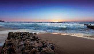 Ocean Waves on scenic Beach at dusk