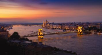 illuminated bridge over the river in budapest at night