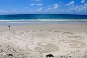 Beautiful drawing of the Ying and the Yang, on the sandy beach