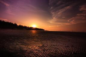 sunset over sandy beach