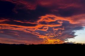 cumulus dark clouds during sunset