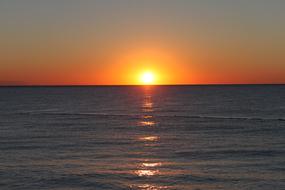 orange sunrise over the ocean, reflection