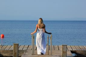 Sea Vacation, girl looking at water from pier, Greece