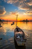 Beautiful waterscape with the boat on the water, at colorful, gradient sunset