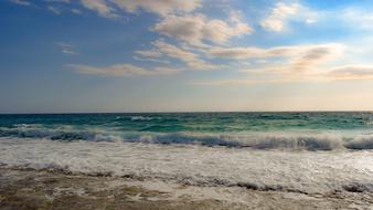 turquoise sea surf splashing on beach